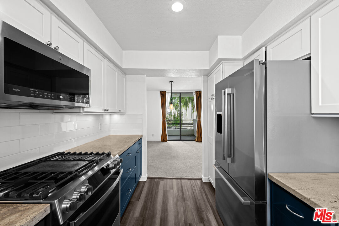 1312 South Saltair Avenue, Unit 215 Los Angeles, CA 90025 - Photo 14 of 31 a kitchen with a stove and a microwave