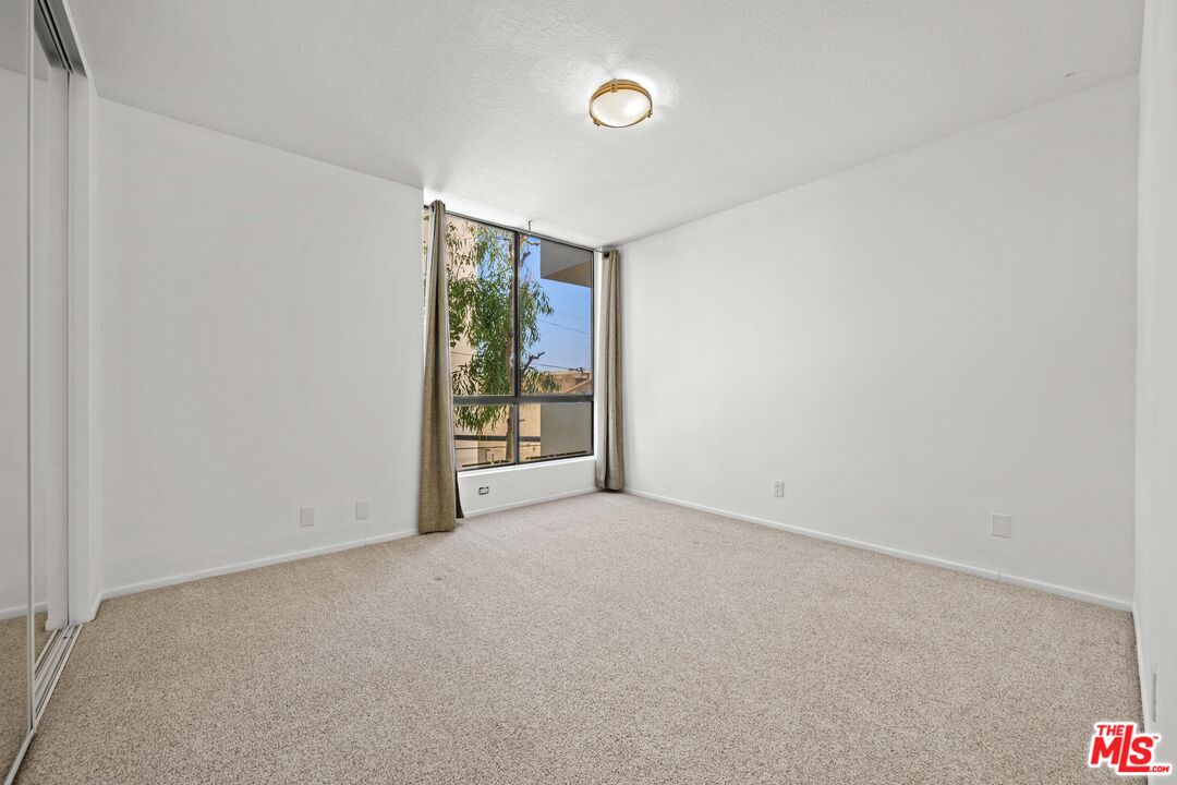1312 South Saltair Avenue, Unit 215 Los Angeles, CA 90025 - Photo 18 of 31 a view of an empty room with a window