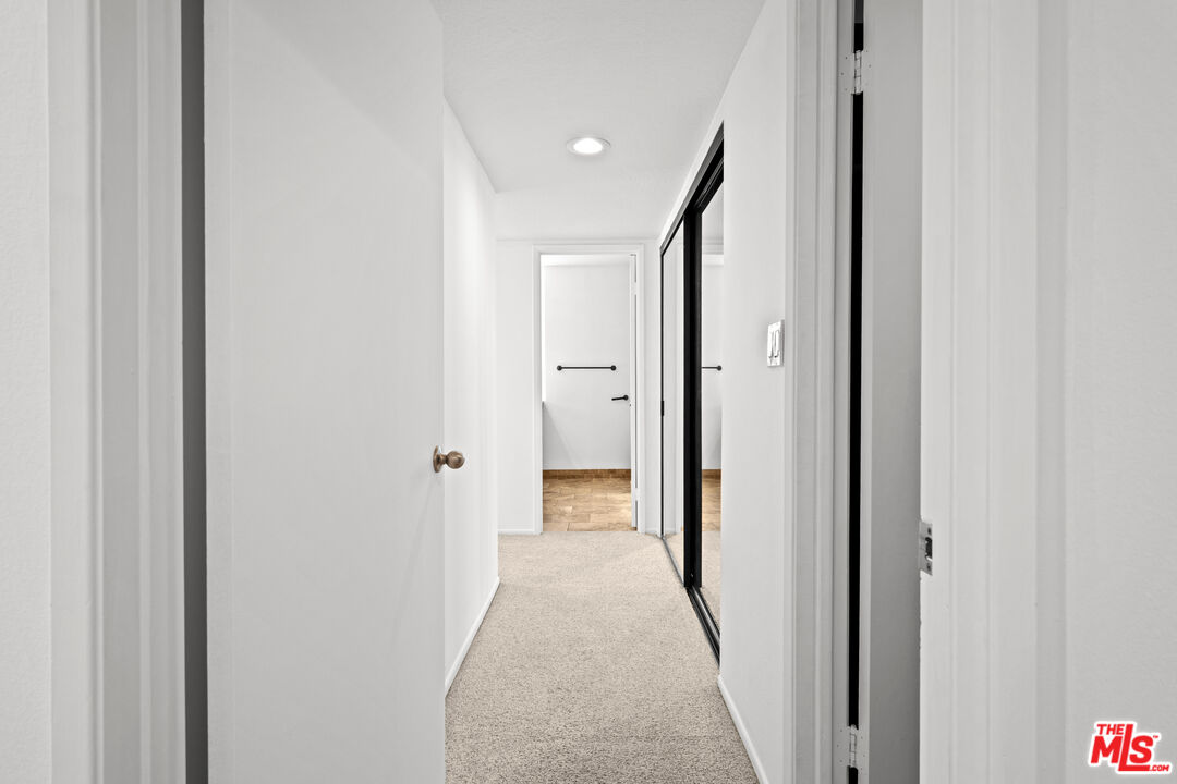 1312 South Saltair Avenue, Unit 215 Los Angeles, CA 90025 - Photo 21 of 31 a view of a hallway with wooden shelves