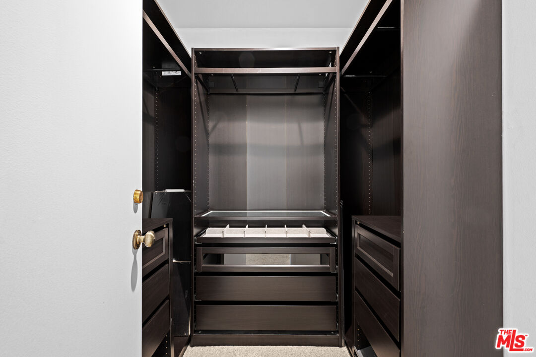 1312 South Saltair Avenue, Unit 215 Los Angeles, CA 90025 - Photo 22 of 31 a view of walk in closet with clothes and shoes