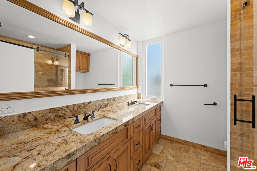 1312 South Saltair Avenue, Unit 215 Los Angeles, CA 90025 - Photo 27 of 31 a bathroom with a sink and a mirror
