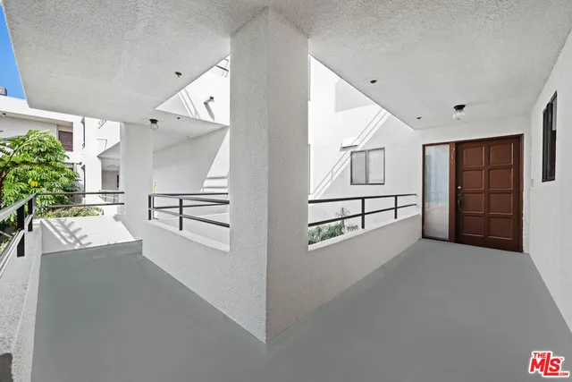 a view of a livingroom with furniture and an empty room