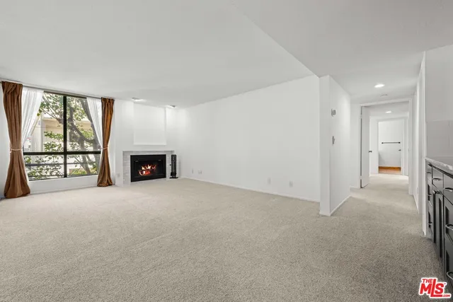 a view of an empty room with a fireplace