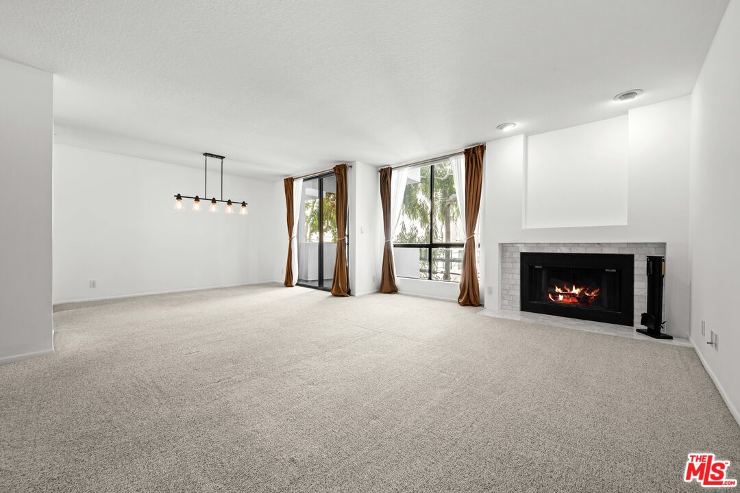 1312 South Saltair Avenue, Unit 215 Los Angeles, CA 90025 - Photo 6 of 31 a view of empty room with a fireplace