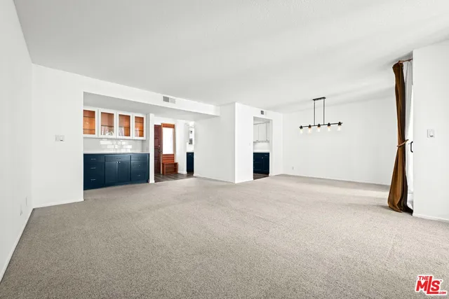a view of a kitchen with a sink and cabinets