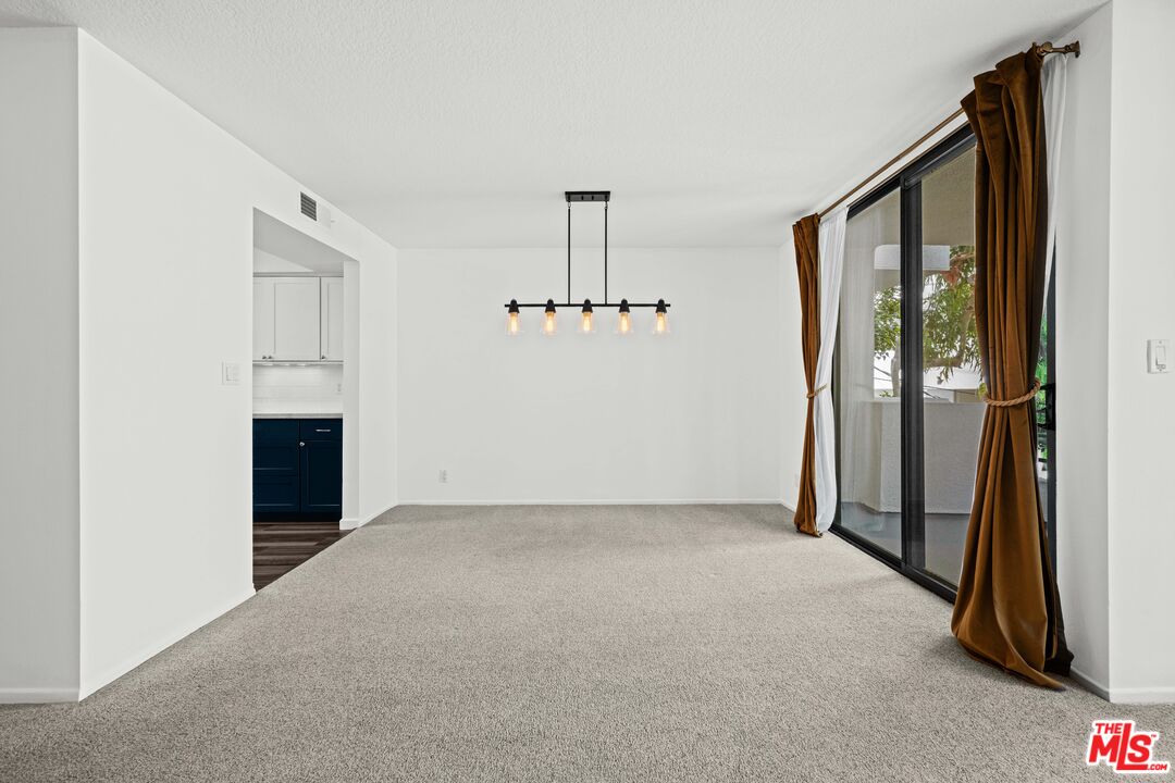 1312 South Saltair Avenue, Unit 215 Los Angeles, CA 90025 - Photo 8 of 31 an empty room with windows