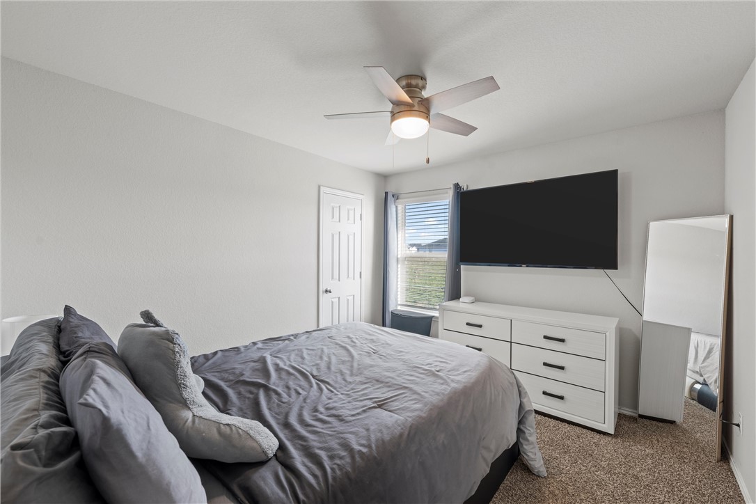 7009 Llano Drive China Spring, TX 76633 - Photo 12 of 25 a bedroom with a bed and a flat screen tv