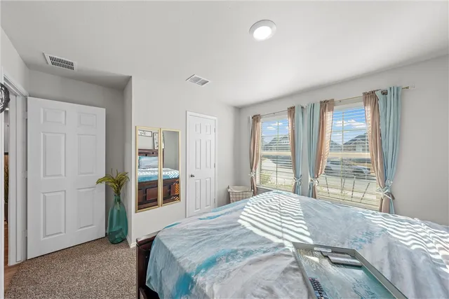 a bedroom with a large bed and a large window