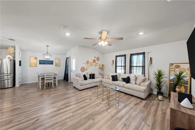 a living room with furniture and a chandelier