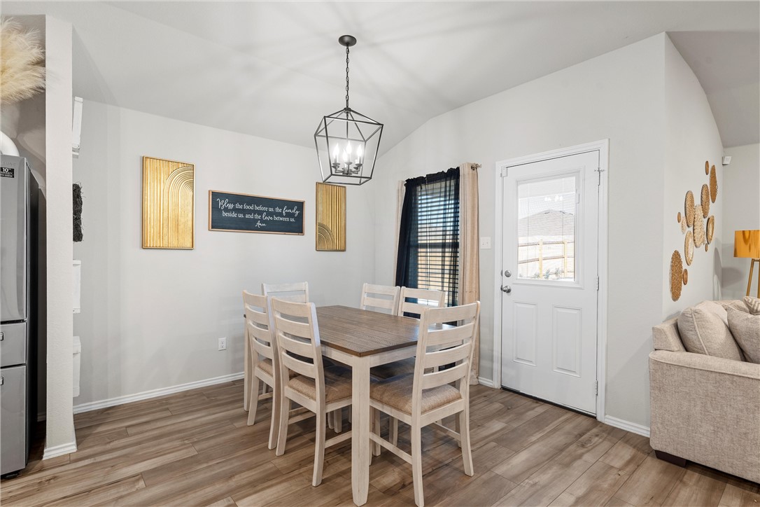 7009 Llano Drive China Spring, TX 76633 - Photo 6 of 25 a view of a dining room with furniture wooden floor and chandelier