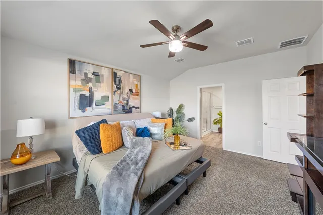 a bed room with a bed and a painting on the wall