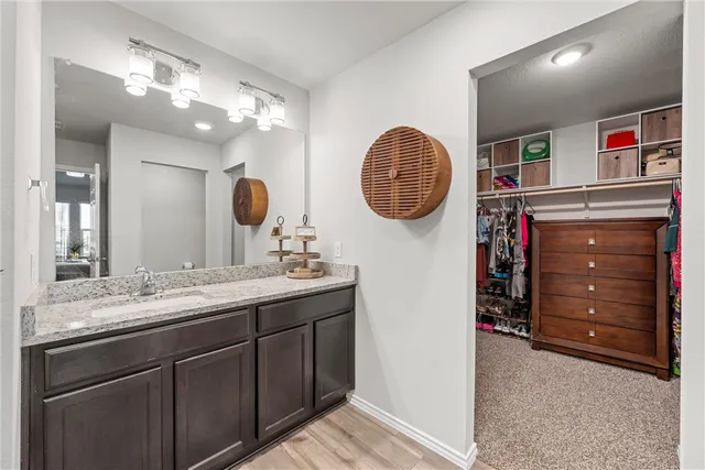 a bathroom with a sink a vanity and a mirror