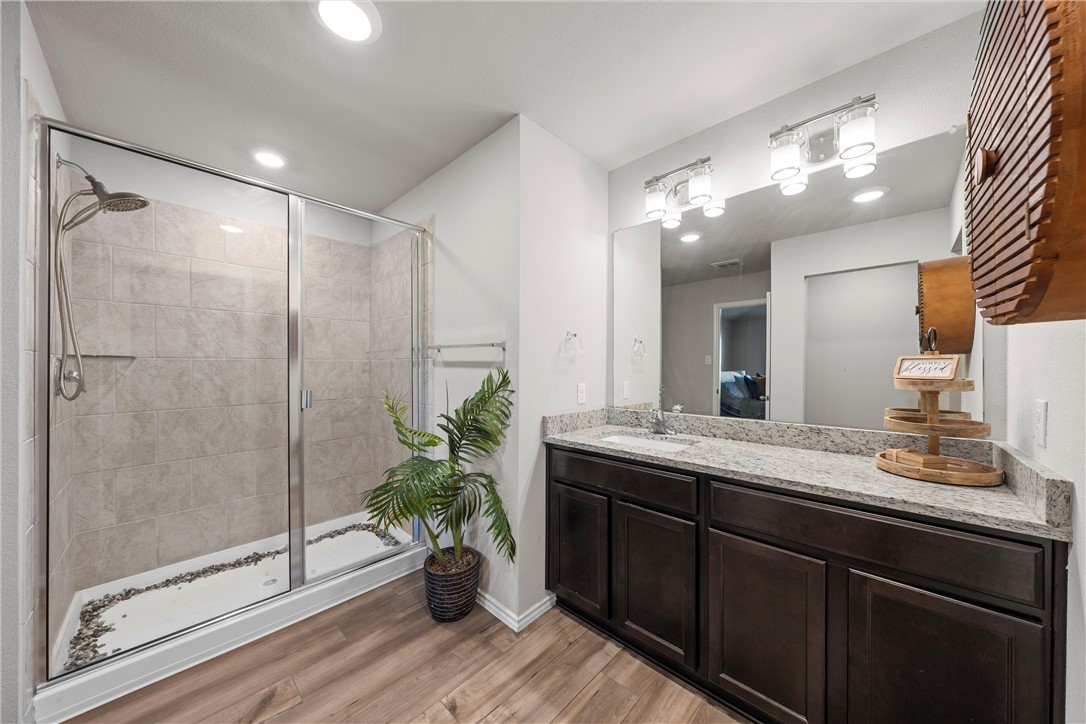 7009 Llano Drive China Spring, TX 76633 - Photo 10 of 25 a bathroom with a shower sink and mirror