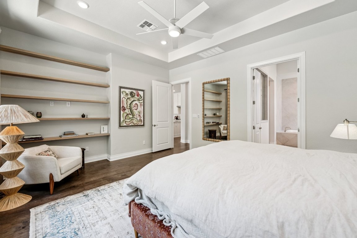 120 Hollytree Court Georgetown, TX 78628 - Photo 18 of 40 a spacious bedroom with a bed and ceiling fan