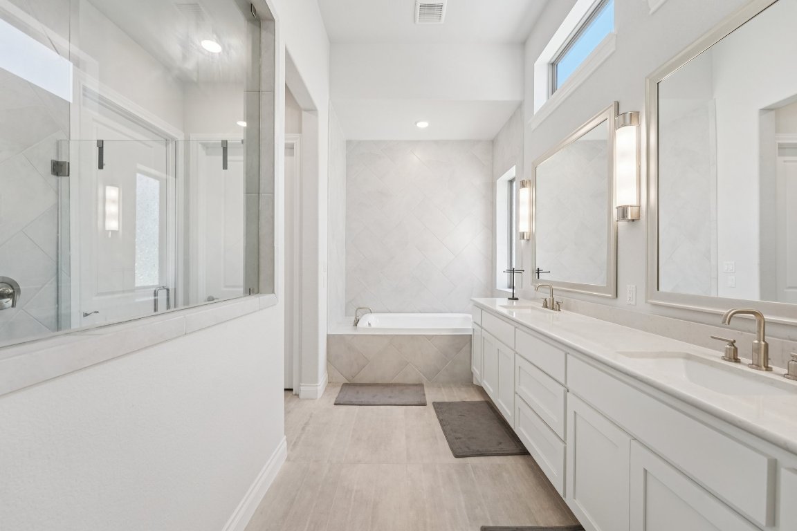 120 Hollytree Court Georgetown, TX 78628 - Photo 20 of 40 a bathroom with a double vanity sink and mirror with shower