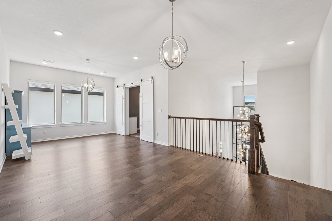 120 Hollytree Court Georgetown, TX 78628 - Photo 25 of 40 a view of a room with wooden floor and white walls