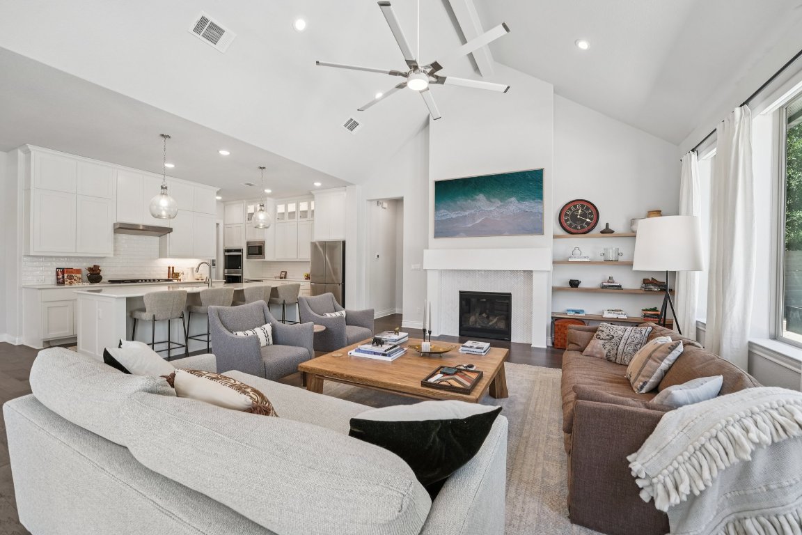 120 Hollytree Court Georgetown, TX 78628 - Photo 9 of 40 a living room with furniture a fireplace and a chandelier