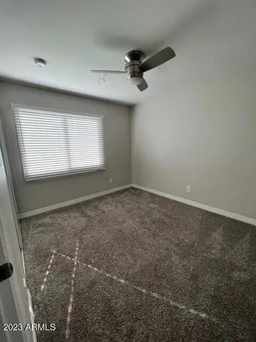 a bathroom with a granite countertop toilet sink and mirror