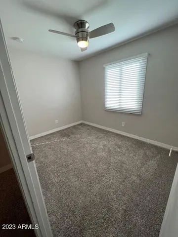 en empty room with windows and cabinet