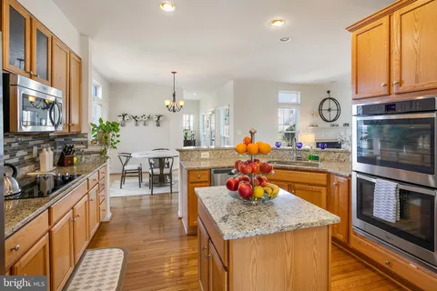 a kitchen with stainless steel appliances granite countertop a stove and a sink with granite countertops