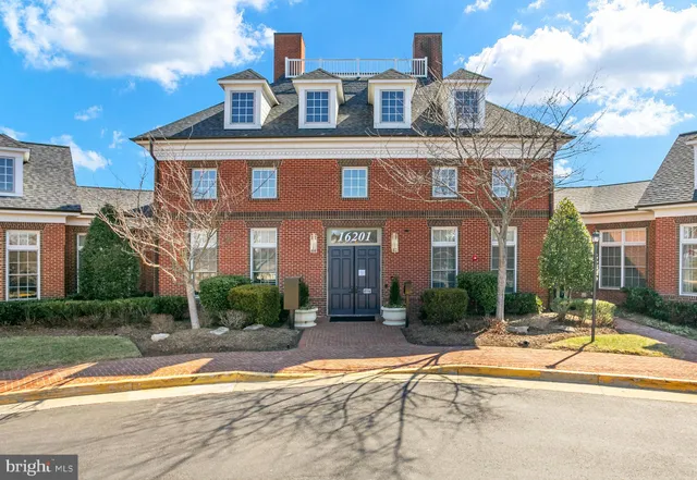 a view of a brick building next to a yard