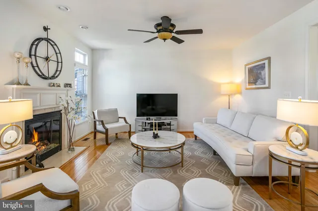 a living room with furniture a fireplace and a flat screen tv