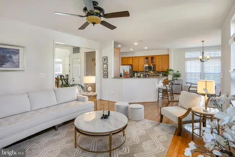 a living room with furniture and a view of kitchen