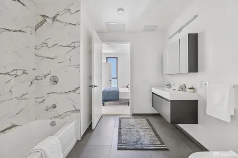 a bathroom with a bathtub a sink and a shower