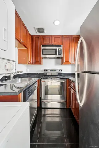 a kitchen with stainless steel appliances granite countertop a stove and a sink