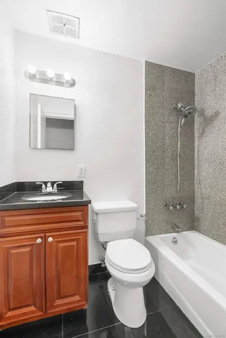 a bathroom with a toilet a sink and bathtub