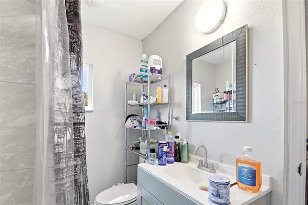 a bathroom with a toilet sink and mirror