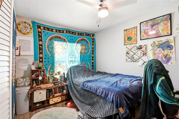 a bed sitting in a bedroom next to a window