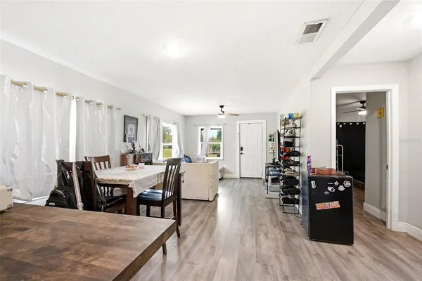 a view of a dining room with furniture and wooden floor