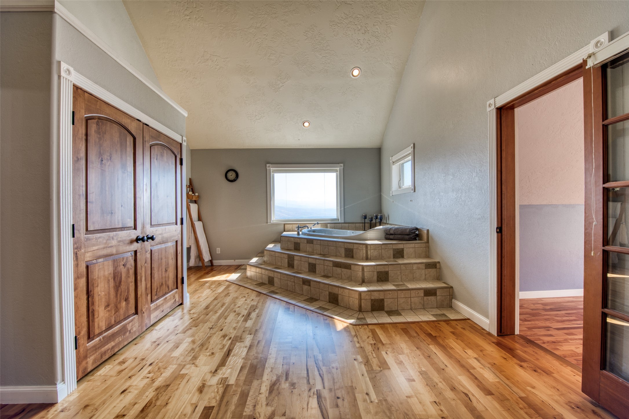 16374 Folsom Road Florence, MT 59833 - Photo 69 of 98 Stairway with lofted ceiling, a textured ceiling, wood-type flooring, and recessed lighting