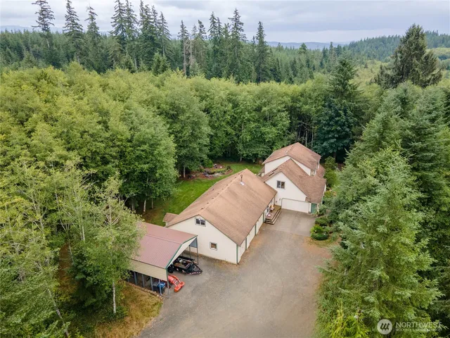 an aerial view of a house with a yard and outdoor seating