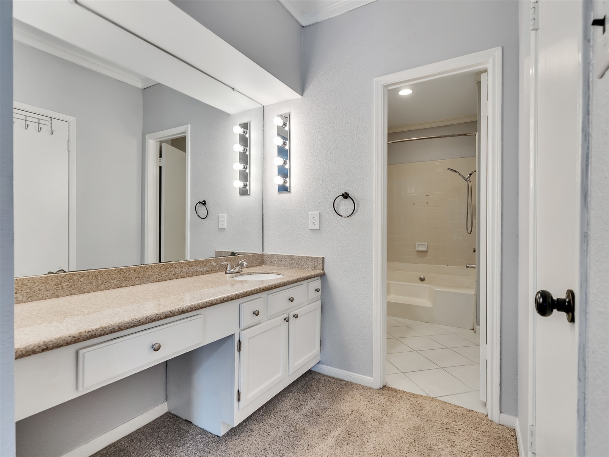 4001 Tanglewilde Street, Unit 605 Houston, TX 77063 - Photo 22 of 29 a bathroom with a granite countertop sink mirror and shower