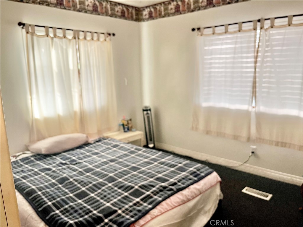 30865 Allen Avenue Homeland, CA 92548 - Photo 11 of 18 a bedroom with a bed and a window