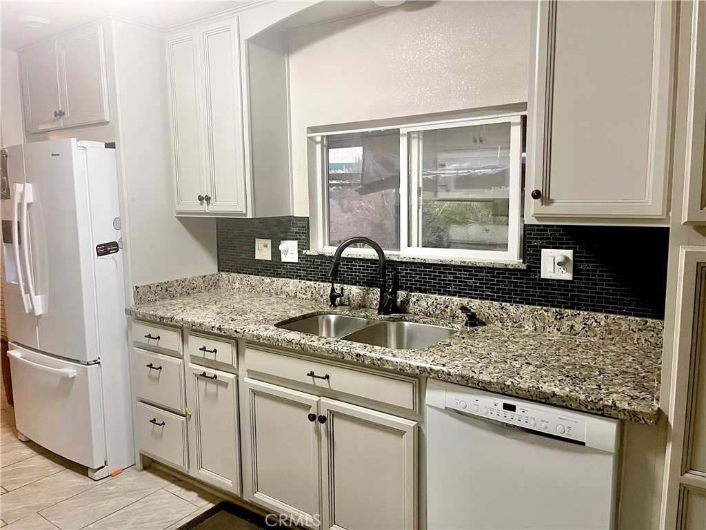 30865 Allen Avenue Homeland, CA 92548 - Photo 12 of 18 a kitchen with white cabinets and a granite counter tops