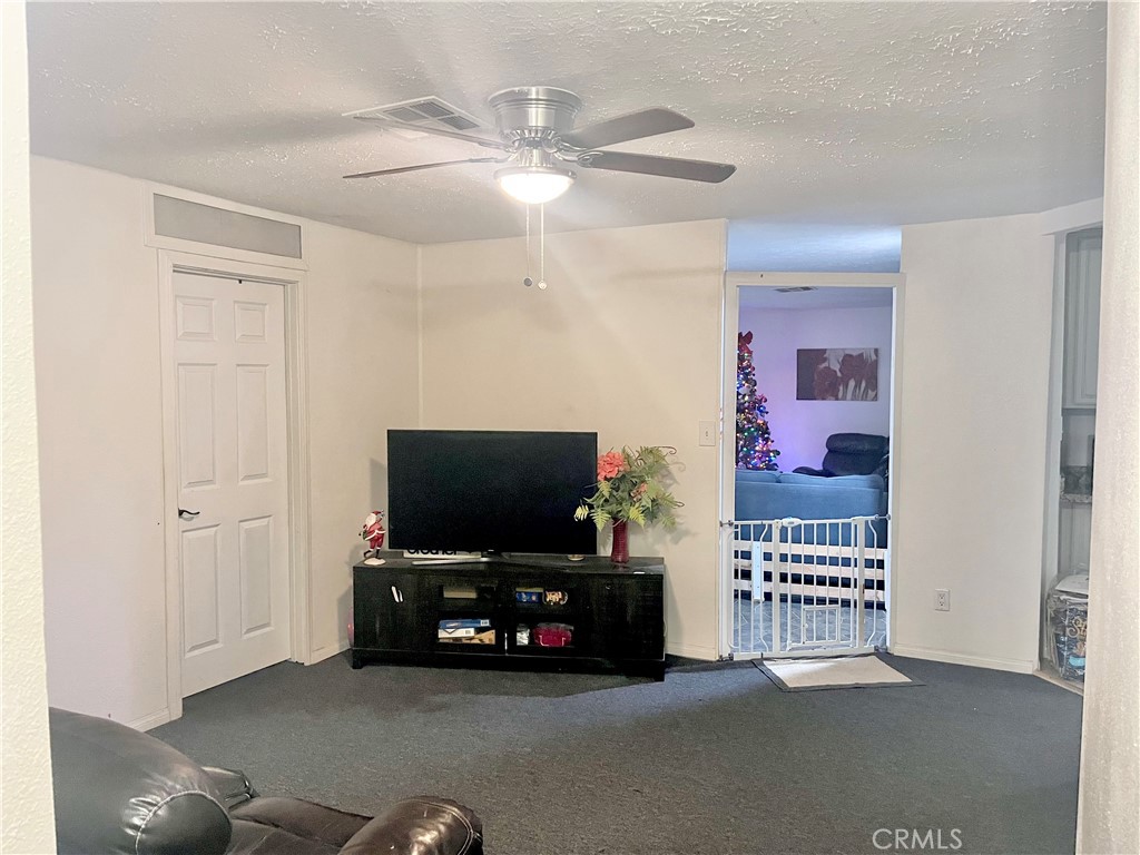 30865 Allen Avenue Homeland, CA 92548 - Photo 4 of 18 a room with furniture and flat screen tv