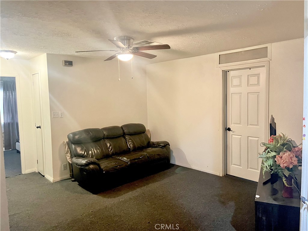 30865 Allen Avenue Homeland, CA 92548 - Photo 7 of 18 a living room with furniture and a potted plant
