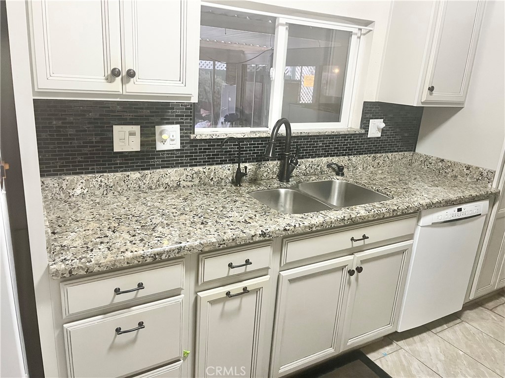 30865 Allen Avenue Homeland, CA 92548 - Photo 9 of 18 a kitchen with granite countertop white cabinets and a granite counter tops