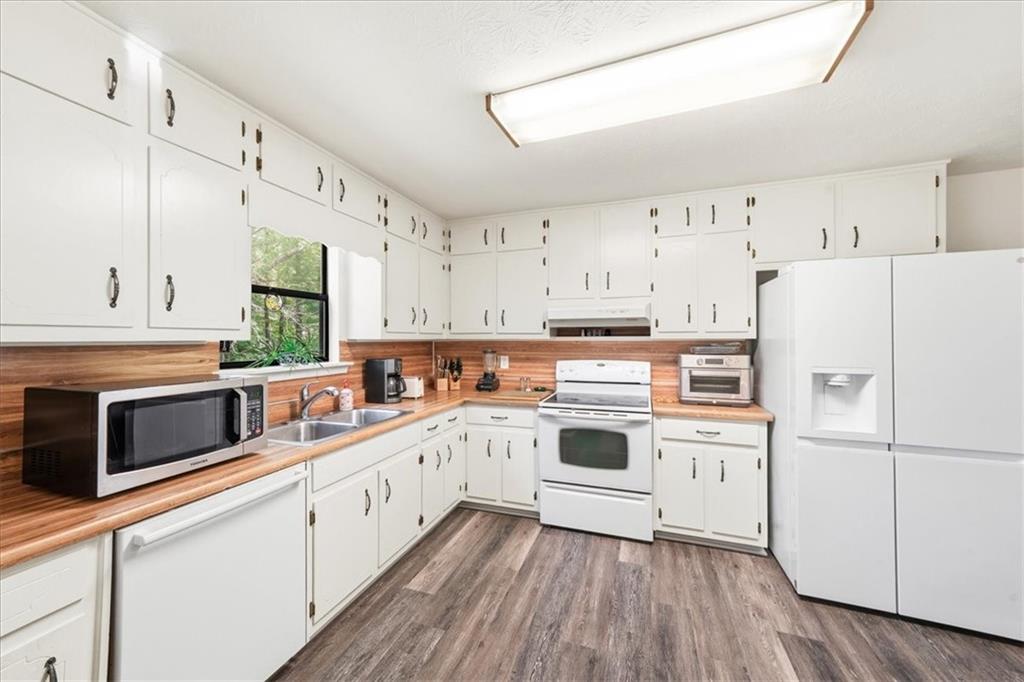 2561 Ripple Way Lawrenceville, GA 30043 - Photo 7 of 19 a kitchen with cabinets stainless steel appliances and wooden floor