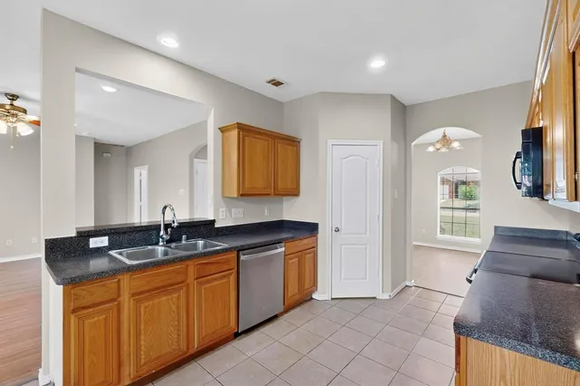 a spacious bathroom with a granite countertop sink and a mirror