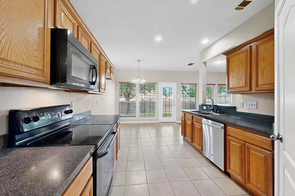 a kitchen with a stove a sink and a microwave