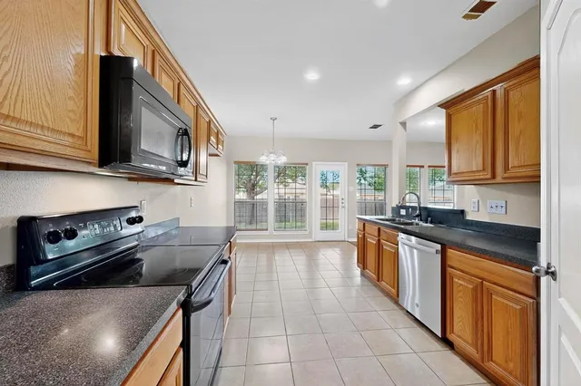 a kitchen with a stove a sink and a microwave