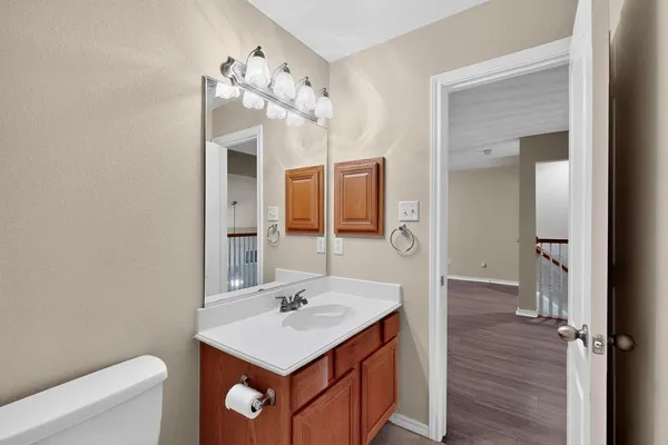 a bathroom with a sink vanity and a mirror