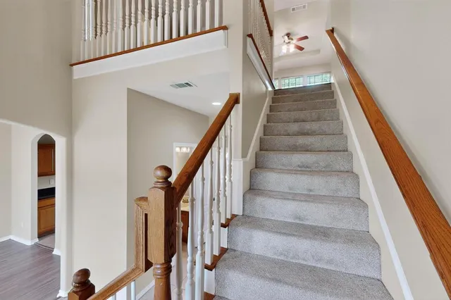a view of staircase with wooden floor and a rug
