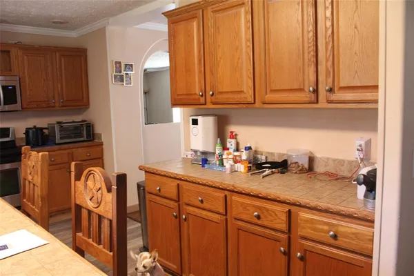a kitchen with stainless steel appliances granite countertop a sink a stove and cabinets