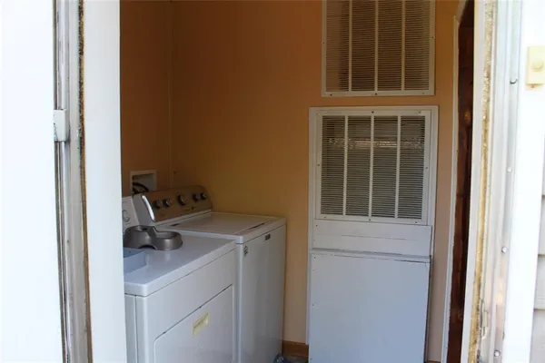 a view of storage and utility room with washer and dryer