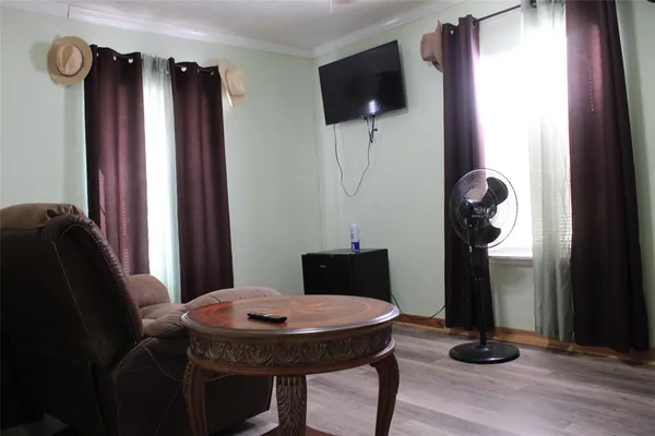 a view of a livingroom with furniture and a window
